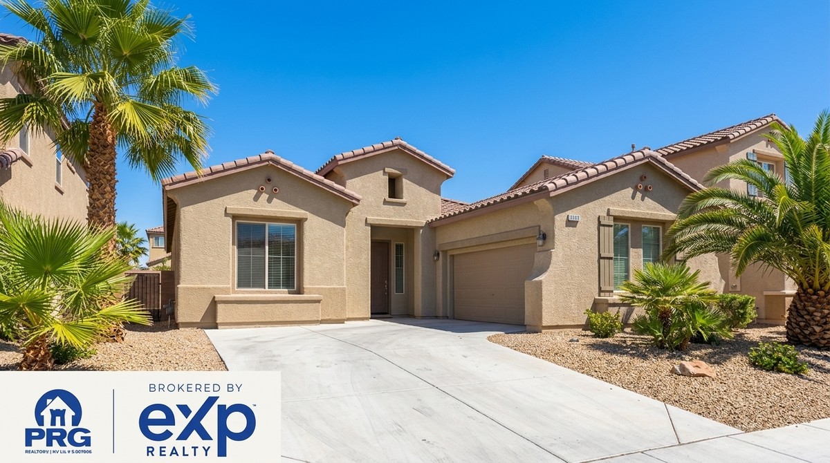 A tan stucco house with a tile roof, palm trees, and a gravel yard under a clear blue sky.
